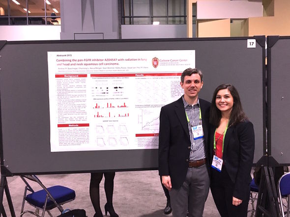 Andrew Baschnagel and student at poster presentation AACR 2017