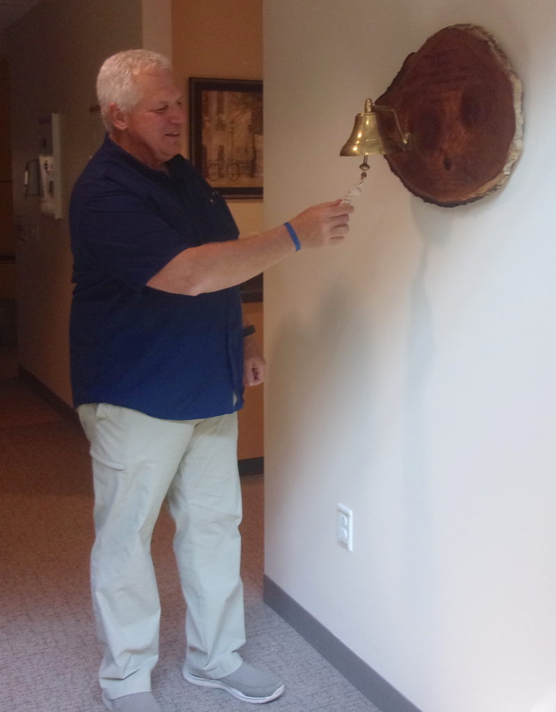 Brad Glassel rings end-of-treatment bell at UW Cancer Center–Johnson Creek