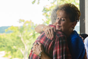 PPeggy Wiederholt, retired UW head and neck cancer nurse, embraces Marshall Flax.