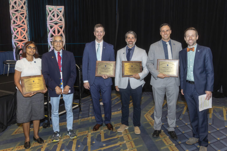 Zac Labby with Bhudatt Paliwal and new Fellows at AAPM awards ceremony.