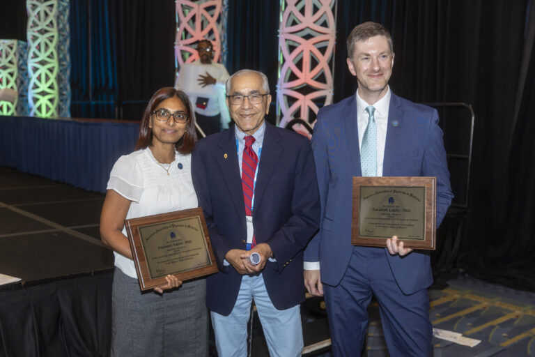 Poonam Yadav, Bhudatt Paliwal and Zac Labby pose with Fellow plaques.